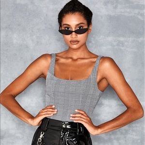 Mistress rocks black and white checked bodysuit